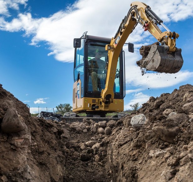 Cat 302 mini excavator at digging works.