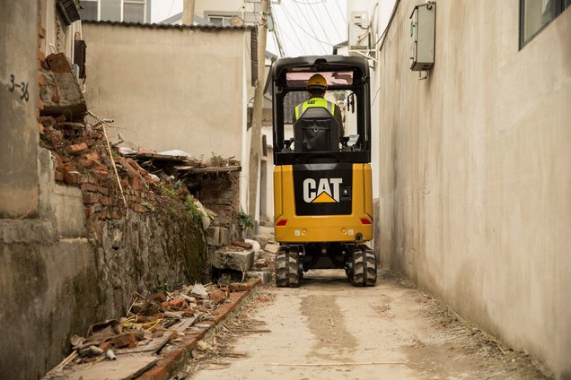 Cat 301.6 model mini excavator working in confined space.