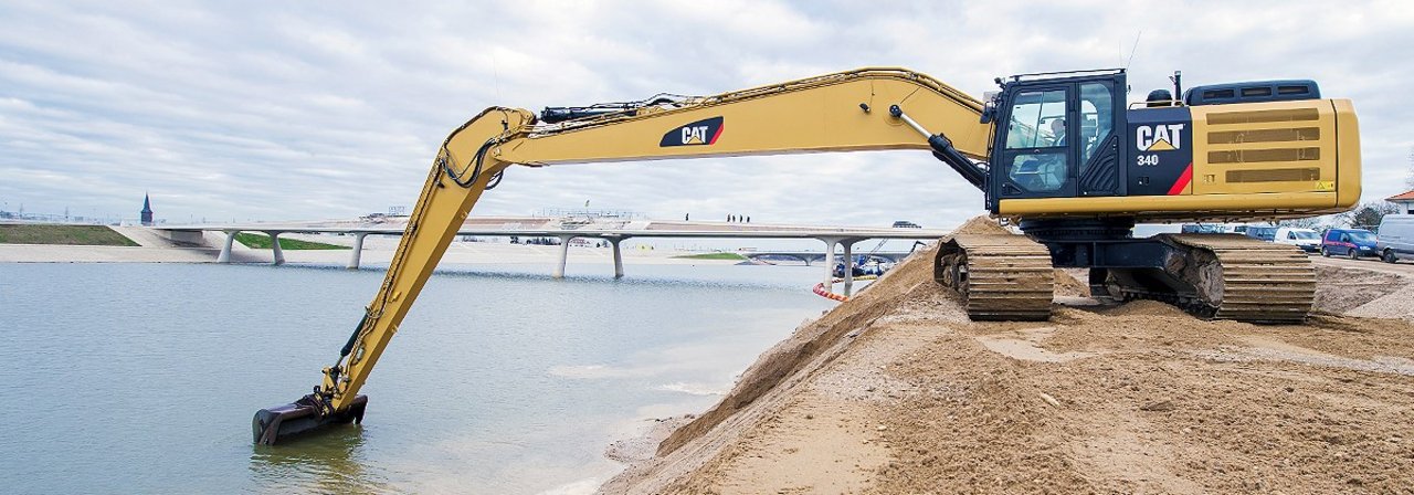 Cat long reach excavator performs digging works